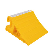 A single yellow wheel chock with a ribbed surface designed to grip wheels, constructed of hard plastic.