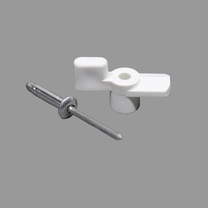 A white turn button latch and a metal rivet placed on a gray surface.