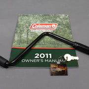 keychain displayed with an owners manual and crank handle