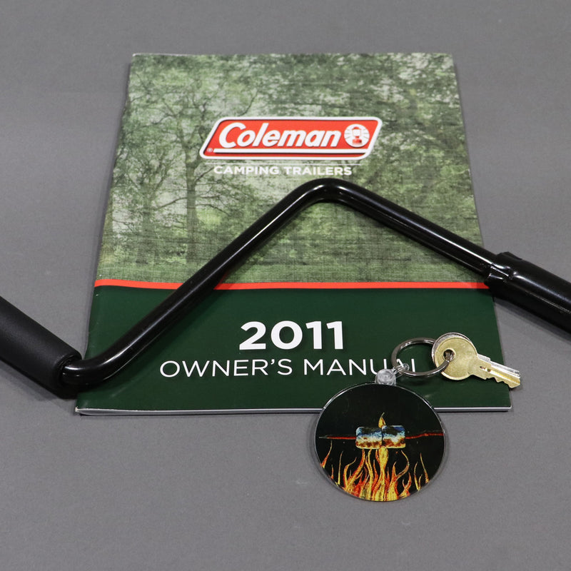 marshmallows keychain shown with a owners manual and crank handle