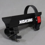 A Yakima crossbar attachment with a black body and red catch area, designed for roof mounted Yakima crossbar systems.