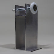 A silver metal roller tower with a white plastic roller wheel, commonly found on RVs, designed for glide out systems.