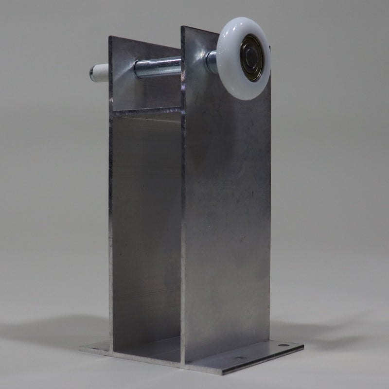 A silver metal roller tower with a white plastic roller wheel, commonly found on RVs, designed for glide out systems.