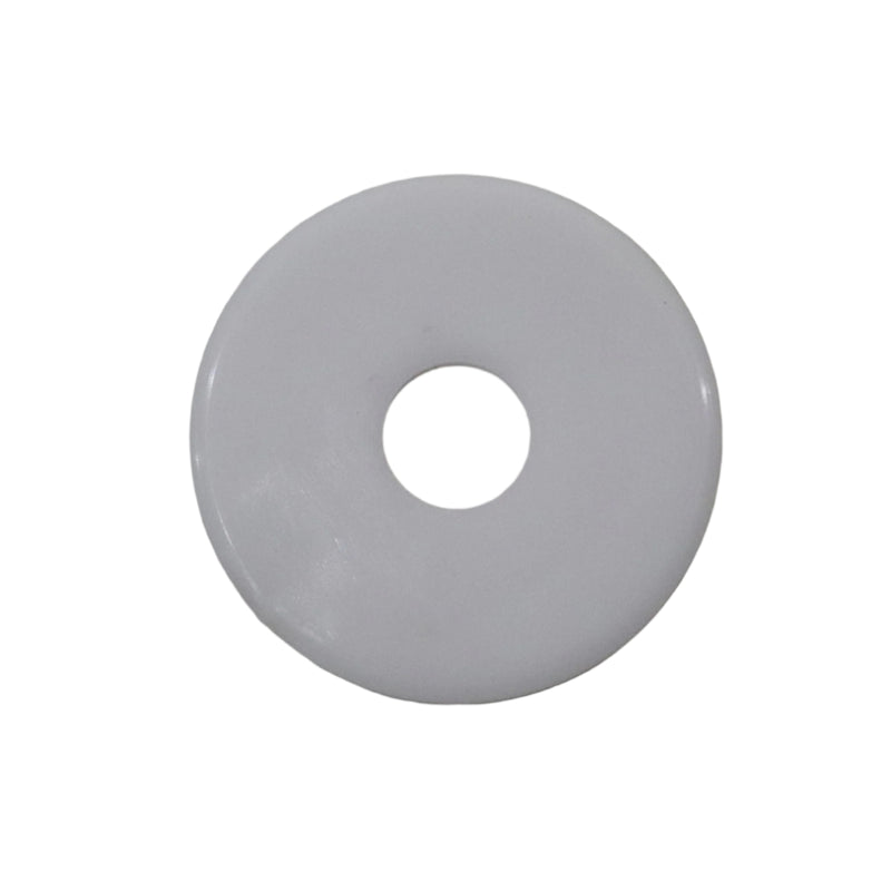 A white washer with a visible center hole, placed on a grey surface.