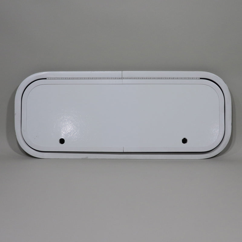 A white camper compartment door with two latch holes.