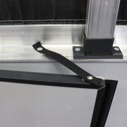 A black metal swing door check attached to a metal frame, with a rivet and screw studs as part of the installation.