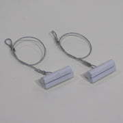 A set of white screen door track guides connected by a metal cable.