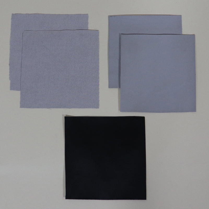 Several patches, including grey fabric and vinyl patches with black borders, arranged against a white background.