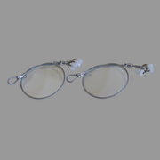 A set of white screen door track guides with a metal cable and silver-colored rollers.