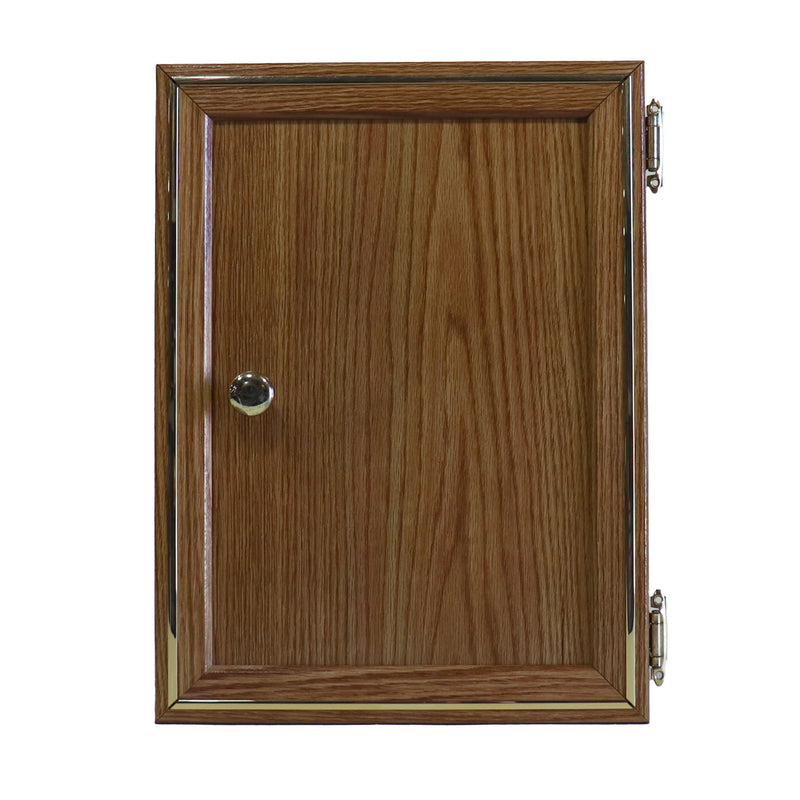 A wooden galley cabinet door with visible grain patterns, a metal hinge on the right side, and a silver knob in the center.