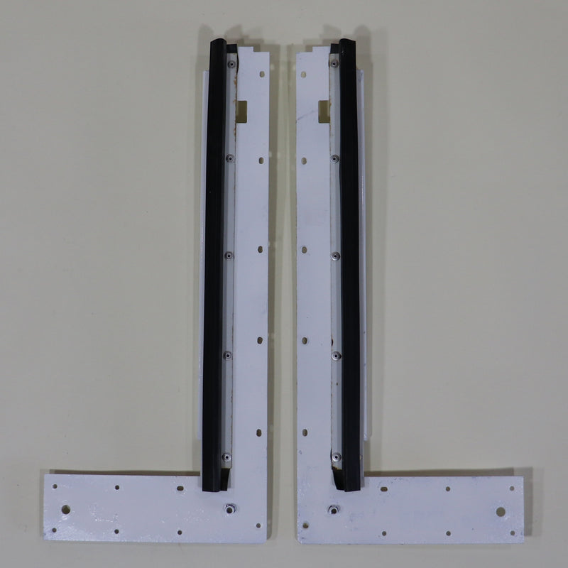 Two white stepper door bulkheads with mounting holes and seals, part of a motor vehicle's interior structure.