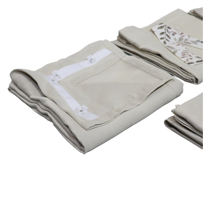 Folded beige towels with white embroidery on a gray surface