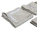 Folded beige towels with white embroidery on a gray surface