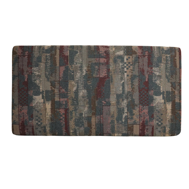 Patterned sofa cushion with multicolor design on a white background