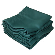 A stack of folded dark green curtains on a solid white background.