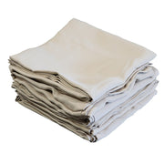 A stack of folded champagne curtains  on a plain white background.
