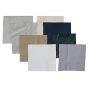 A set of eight square patches  in various colors and textures, arranged in a fan-like layout on a solid white background. The colors include white, light gray, beige, navy blue, and dark green.