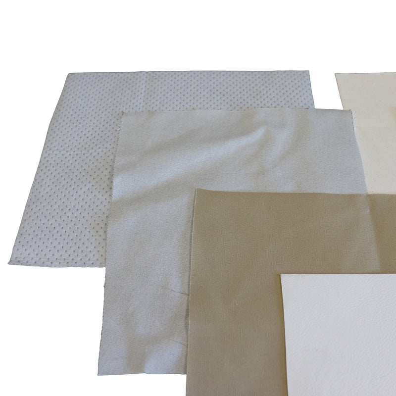 Several square patch swatches in neutral tones are arranged overlapping on a white background, including a white patterned piece, a light gray fabric, a tan sheet, and a white textured sheet.