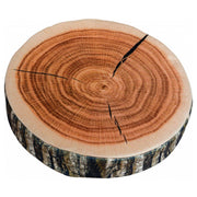 A round pillow designed to resemble a cross-section of a tree trunk with visible annual rings and a textured edge.