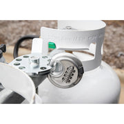 A propane tank lock with a combination lock mechanism is installed on a white propane tank.