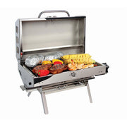 A portable stainless steel Olympian 5500 low pressure grill with food on its grates, set up on a stand.