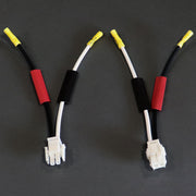 A set of battery harness repair kit components with red and black coloring and yellow connectors.