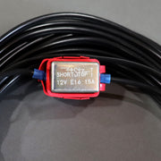 A black auto extension battery harness with red and yellow alligator clips and a white connector showing the fuse