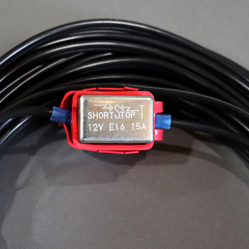 A black auto extension battery harness with red and yellow alligator clips and a white connector showing the fuse