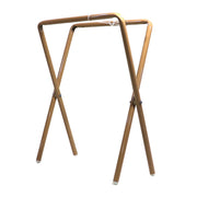 A pair of light tan colored folding table legs, designed to be clipped under a table top.