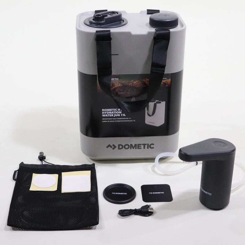 A Dometic water jug and USB powered faucet set, including mounting bases, a USB cable, and other accessories, displayed on a white surface.