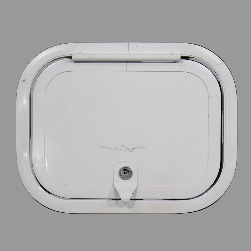 A white compartment door with a cam lock mechanism, likely made of plastic or metal, used for storage purposes in vehicles.