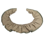 A beige and green colored valance with a ruffled design and a central grommet, displayed on a flat surface.