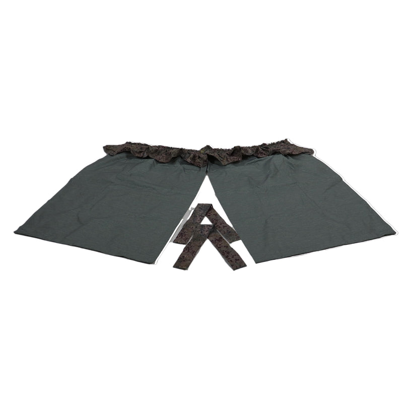 Tip out curtains with valance installed on a tent, featuring a dark color with a decorative border at the top.