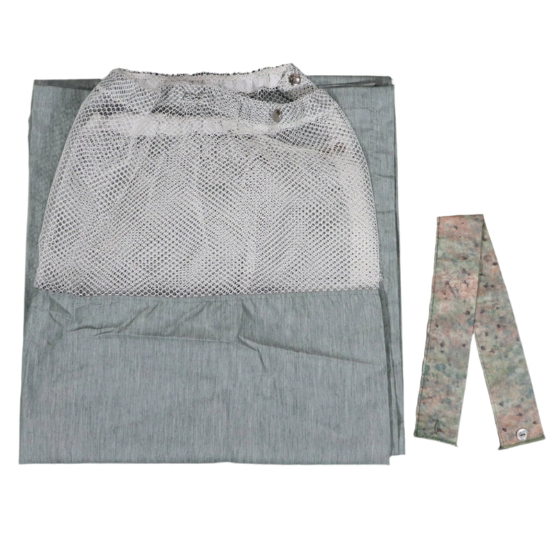 A light green dressing room curtain with white mesh top and a curtain tie, laid flat on a gray surface.