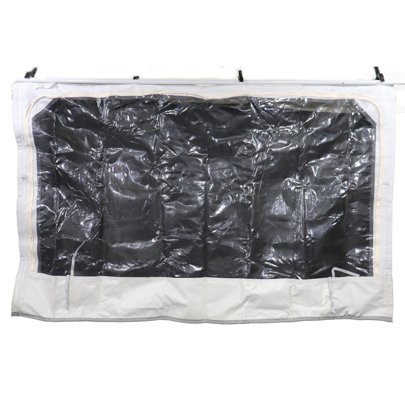 A large canvas window for a coleman pop-up camper, grey in color with black window backing