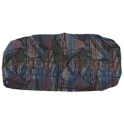 A multicolored cushion cover with a pattern that includes shades of blue, red, and beige.