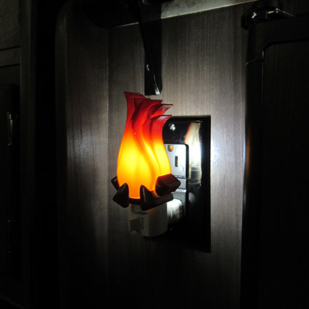 campfire nightlight shown illuminated in a camper