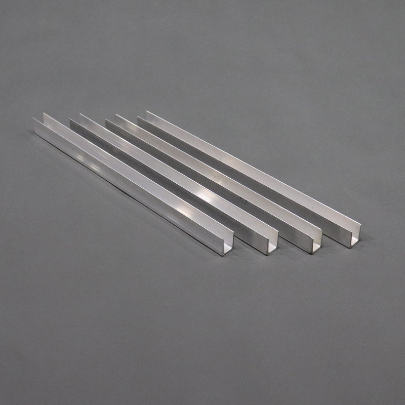 A set of four silver-colored aluminum channel braces laid out on a gray surface.