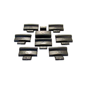 A collection of black hub cap clips arranged on a surface.