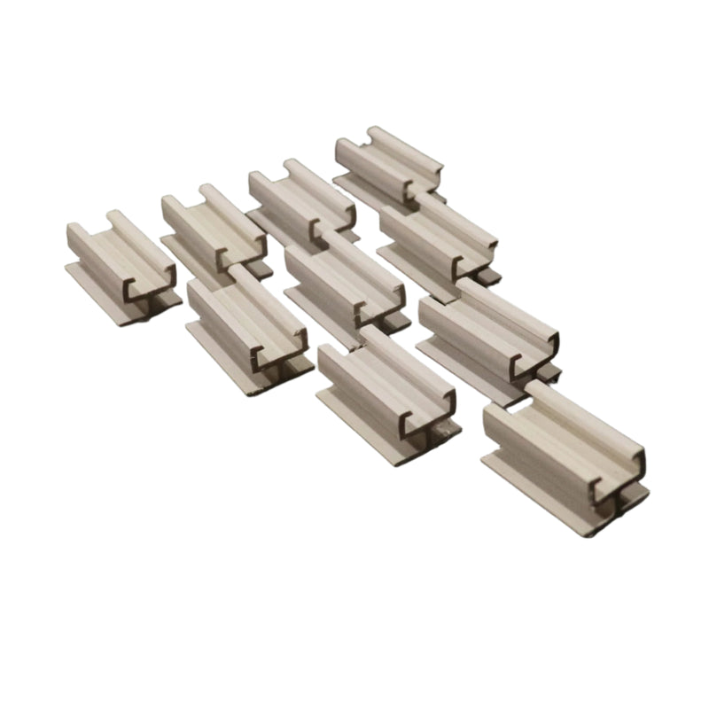A collection of beige colored valance track adapters arranged in rows on a white background.
