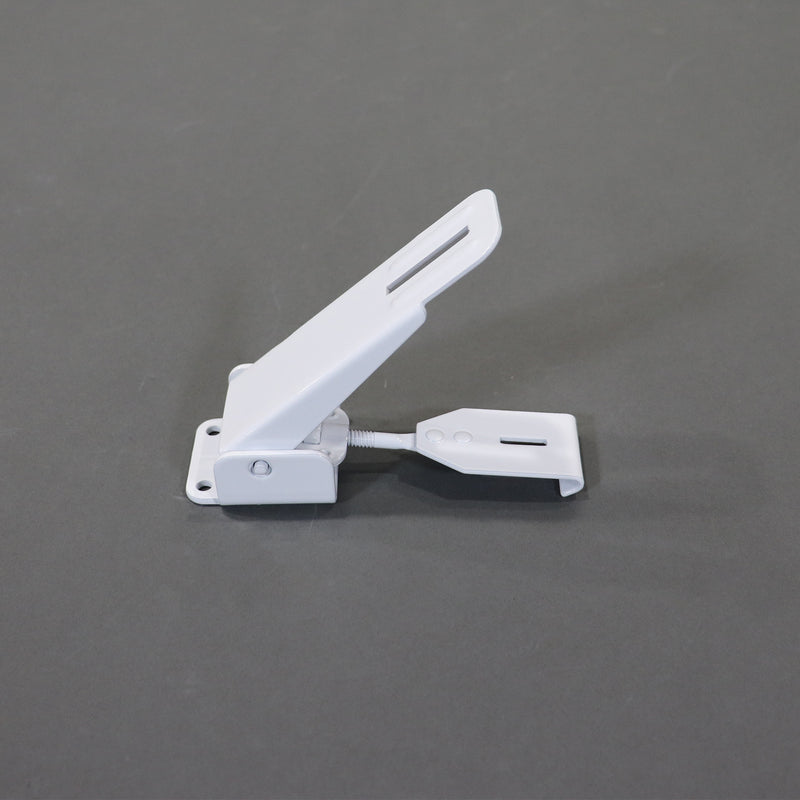 A white metal latch for securing the roof and storage boxes on pop-up campers.