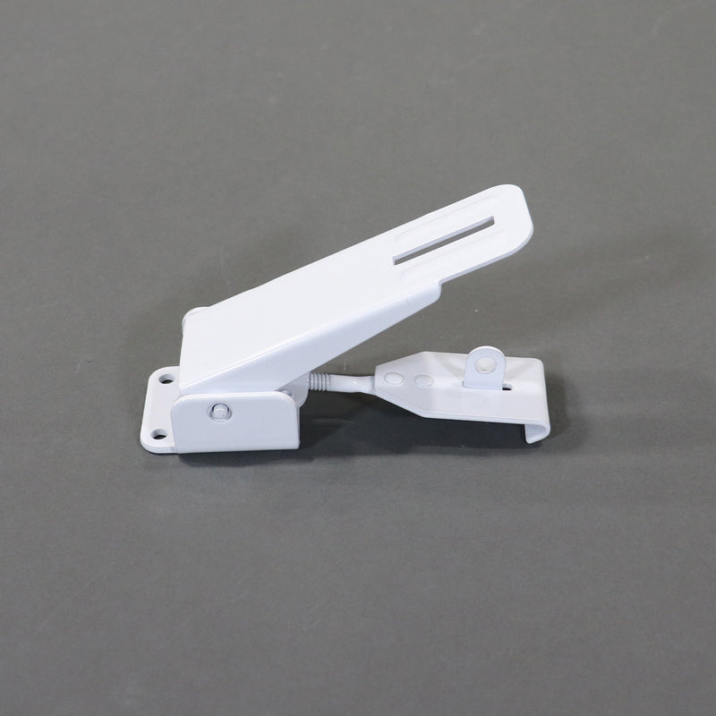 A white metal latch for securing the roof and storage boxes on a pop-up camper.