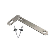 A metal swing arm kit with two rivets placed on a grey surface.
