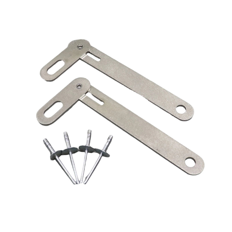 A metal swing arm kit with four rivets placed on a grey surface.