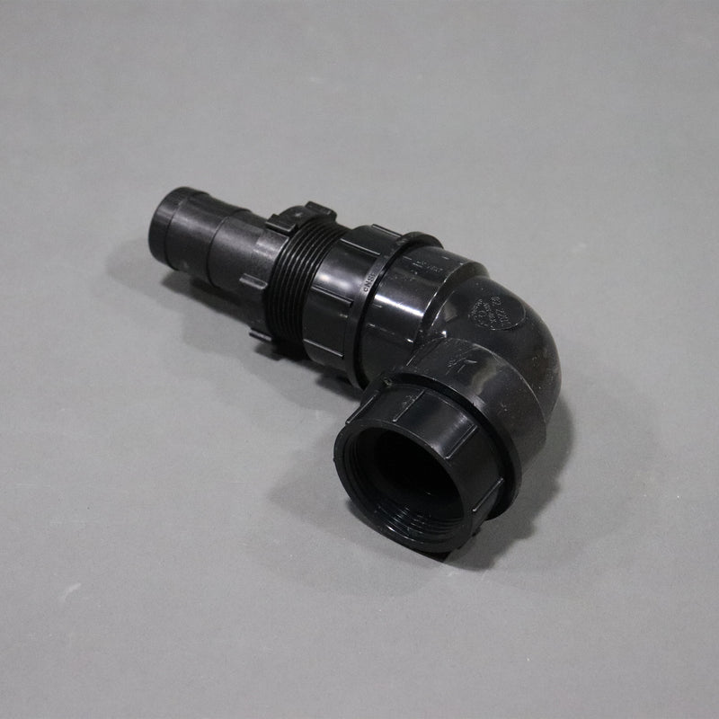 A black sink drain elbow, approximately 7 inches long by 4 inches tall.