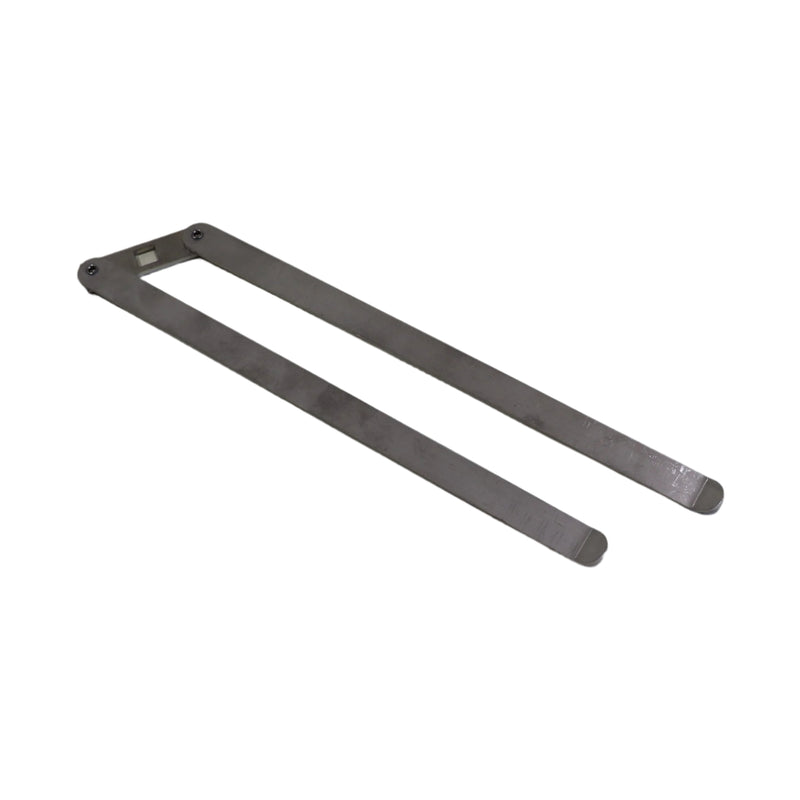 A metal lock bar assembly laid on a white surface.