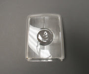 A clear lens for a ceiling lamp, with visible ridges on the surface, against a grey background.