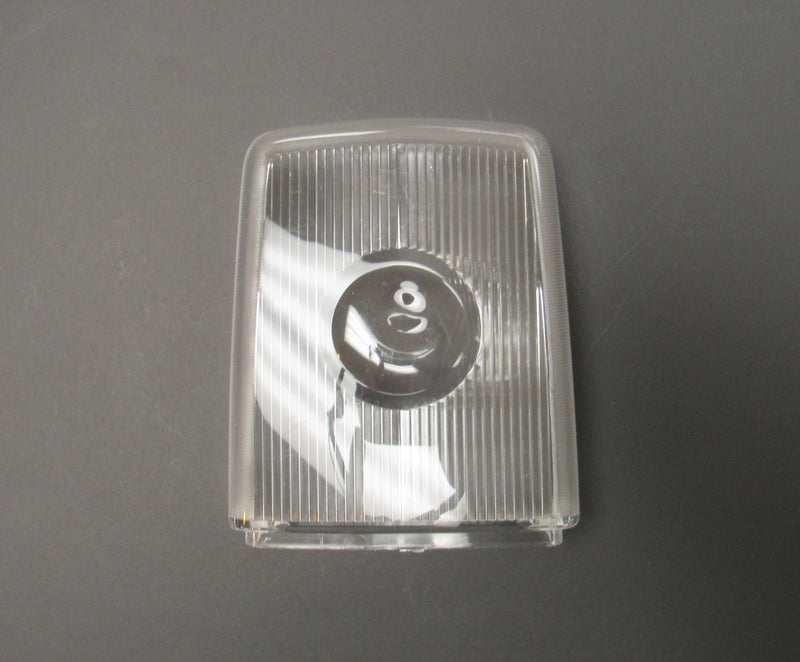 A clear lens for a ceiling lamp, with visible ridges on the surface, against a grey background.
