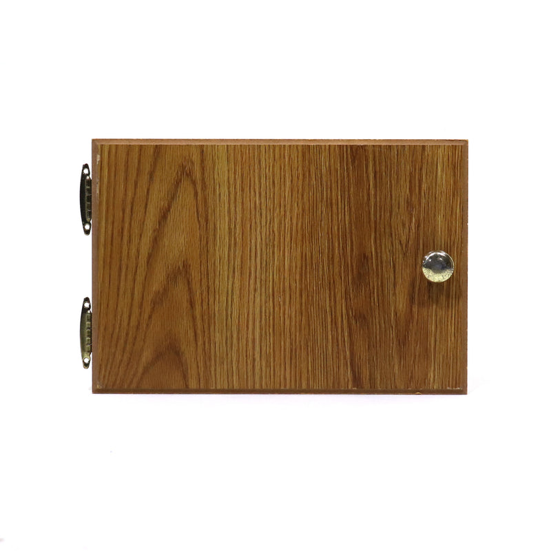 A wooden cabinet door with a visible grain pattern, featuring a metal latch and hinges.