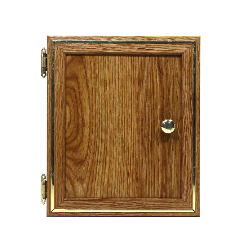A used wooden cabinet door with gold trim molding and a visible hinge on the left side.